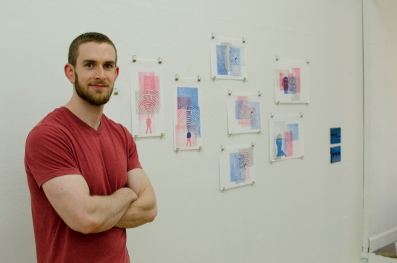 The artist poses in front of his prints!